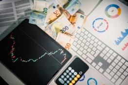 a-calculator-sitting-on-top-of-a-pile-of-money.jpg A calculator sitting on top of a pile of money